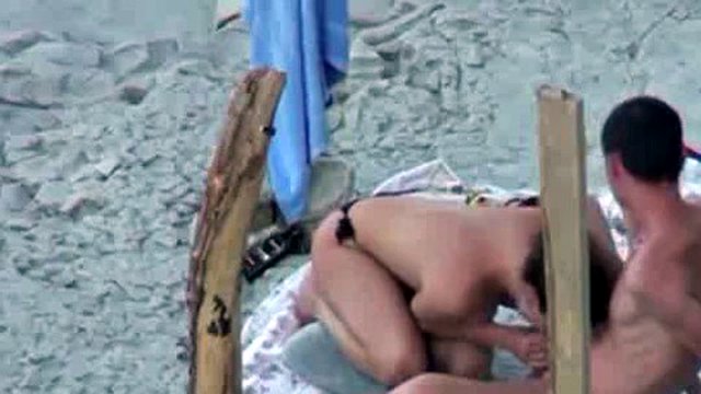 A couple is spying on camera at the beach