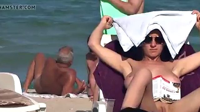 A man is interested in the naked body of a housewife on the beach