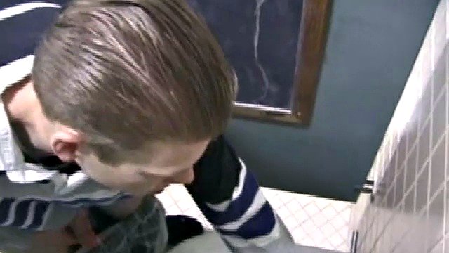 We catch up with Christian on the outside stairs. He takes us to the men's room with glory holes. There's Christian jerking off in a straight porn magazine photo.