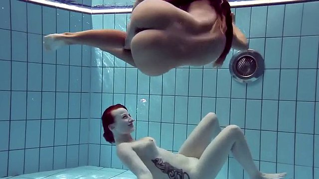 naughty katrin and lucy swim naked in a swimming pool