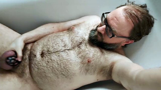 Some solo chastity watersports in the bathroom for this pee-thirsty locked-up bear