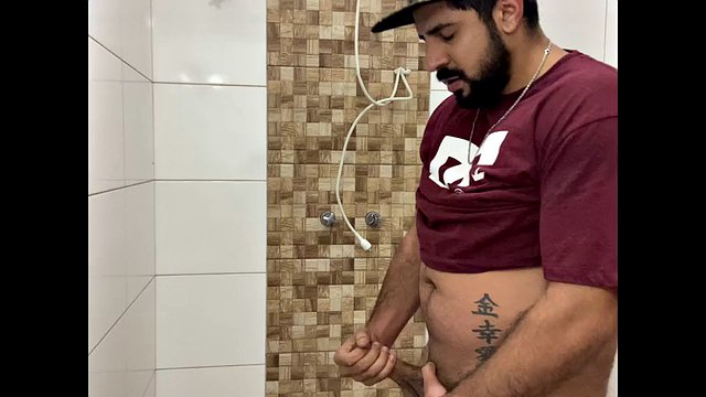 Squirting cum, bearded man with a cap alone in the bathroom having fun in the handjob until he cums a lot - Rodrik Dick