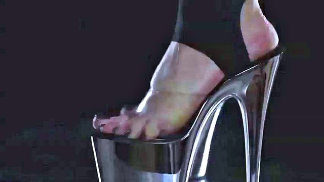 Latex suit male slave licking the feet of his mature mistress