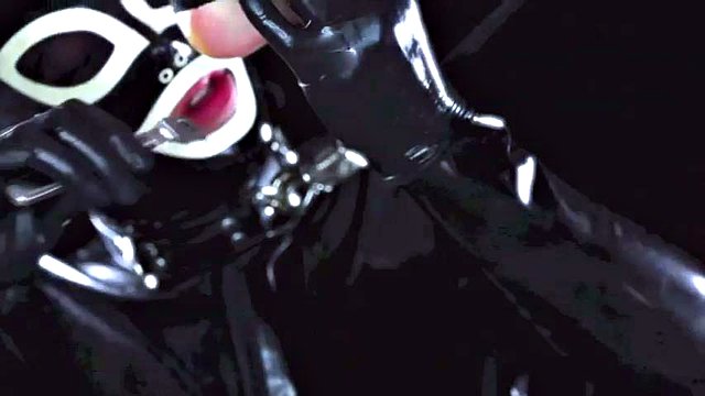 Latex suit male slave licking the feet of his mature mistress