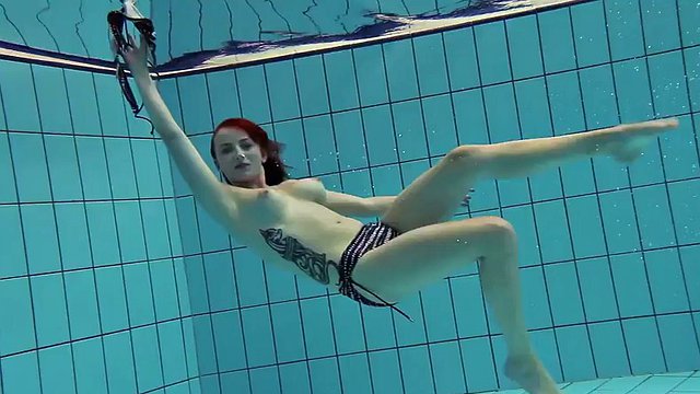 Redhead Katrin strips naked underwater