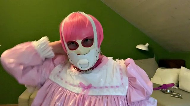 Sissy in diaper with bondage hood